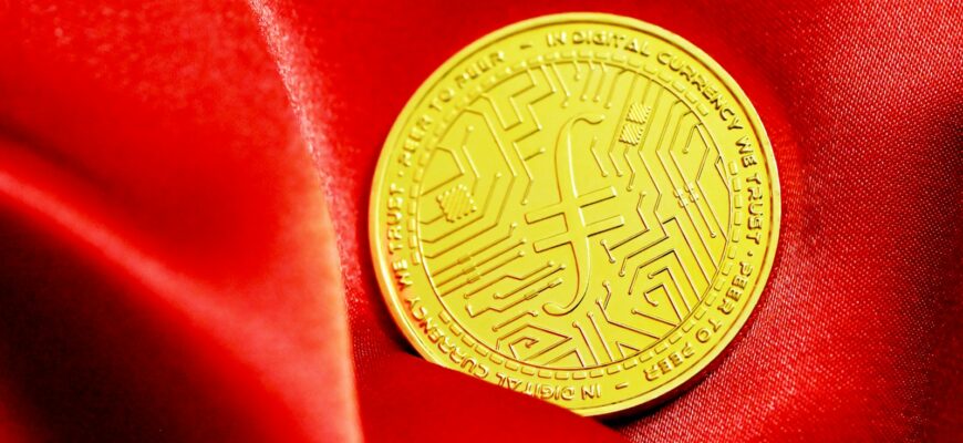 a close up of a gold coin on a red cloth