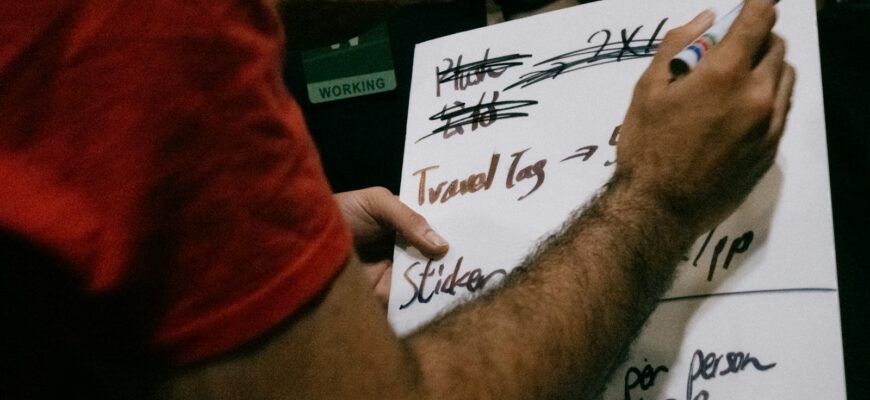 Someone is writing notes on a whiteboard.