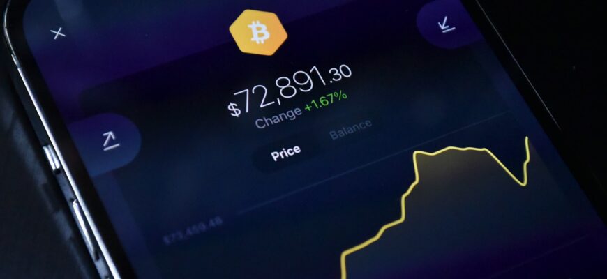 a cell phone displaying bitcoin on the screen