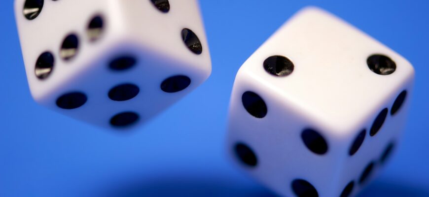 2 white dices on blue surface