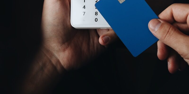 A person holding a credit card in their hand