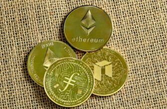 three gold coins with a bitcoin on top of them